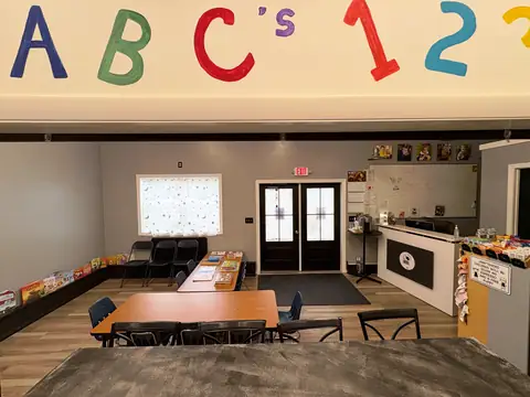 The hand-painted ABC's and 123 mural above the front desk