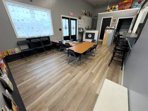 Party tables, folding chairs, and the cafe counter with barstools