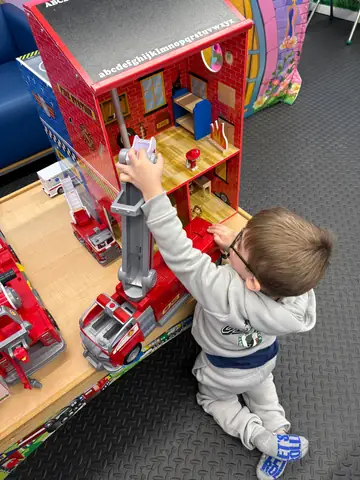 A child playing at the fire station