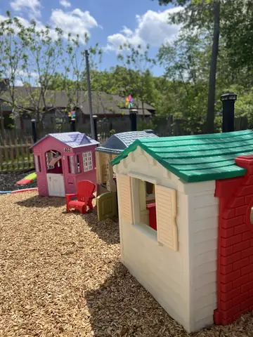 Playhouses in The Neighborhood in the outdoor play yard
