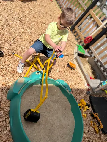 Working the sand digger beside the sandbox