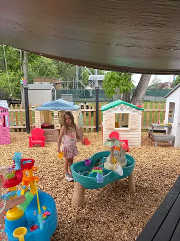 The fenced outdoor play yard