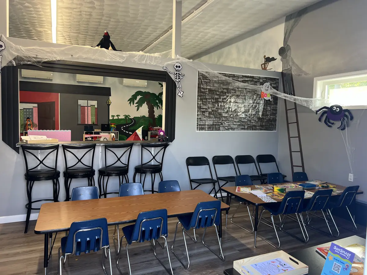The Snack Stop cafe counter with barstools and low kid-sized snack tables