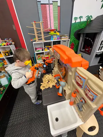 A child at the workshop and car station